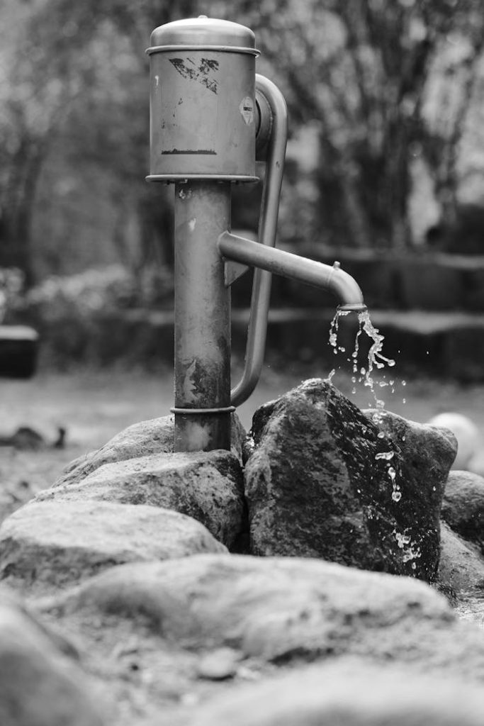 A black and white photo of a water fountain